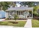 Charming one-story home with gray siding, landscaped yard, and covered porch with seating area at 1257 Lyle Pl, Atlanta, GA 30318