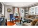 Bright living room featuring hardwood floors, comfortable seating, and a large window with curtains at 1257 Lyle Pl, Atlanta, GA 30318