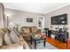 Comfortable living room with hardwood floors, neutral walls, a plush sofa, and a flat screen television at 1257 Lyle Pl, Atlanta, GA 30318