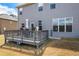 View of gray back deck with outdoor seating and an ADT security sign at 1861 Poplar Falls Ave, Lithonia, GA 30058
