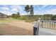 Expansive backyard with a charming lake view, a fire pit, and access to the deck at 1861 Poplar Falls Ave, Lithonia, GA 30058