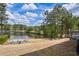 Serene backyard overlooking a lake, complete with a fire pit seating area and lush greenery at 1861 Poplar Falls Ave, Lithonia, GA 30058