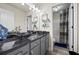 Stylish bathroom features double sinks, dark granite counters, and modern lighting at 1861 Poplar Falls Ave, Lithonia, GA 30058