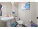 Charming half bath with a pedestal sink, elegant decor, and contemporary fixtures at 1861 Poplar Falls Ave, Lithonia, GA 30058