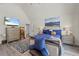 Bright bedroom featuring wood look floors, a TV, and an accent chair at 1861 Poplar Falls Ave, Lithonia, GA 30058