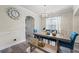 Comfortable dining area with gray floors, chandelier, and chairs with rich blue upholstery at 1861 Poplar Falls Ave, Lithonia, GA 30058