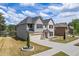Beautiful exterior of a two-story home with a manicured lawn and attached garage near the lake at 1861 Poplar Falls Ave, Lithonia, GA 30058