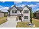Inviting two-story home with a well-maintained lawn and attached two car garage at 1861 Poplar Falls Ave, Lithonia, GA 30058