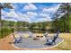 Backyard fire pit area with chairs and a view of the lake at 1861 Poplar Falls Ave, Lithonia, GA 30058