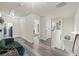 Bright hallway showcasing a green velvet couch, natural light, and an open floor plan at 1861 Poplar Falls Ave, Lithonia, GA 30058