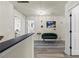 Hallway space featuring a green velvet sofa, natural light, and access to multiple rooms at 1861 Poplar Falls Ave, Lithonia, GA 30058