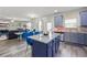 Open layout featuring an island with granite countertops and seamless flow into the dining area and kitchen at 1861 Poplar Falls Ave, Lithonia, GA 30058