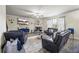 Cozy living room features plush leather seating, a stone fireplace, and natural light from large windows at 1861 Poplar Falls Ave, Lithonia, GA 30058