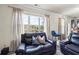 Living room view showcasing a large window overlooking a lake and comfortable leather seating with stylish pillows at 1861 Poplar Falls Ave, Lithonia, GA 30058