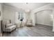 Inviting living room featuring hardwood floors, and a stylish chandelier at 1861 Poplar Falls Ave, Lithonia, GA 30058