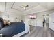 Comfortable bedroom featuring wood floors, tray ceiling, and a large TV at 1861 Poplar Falls Ave, Lithonia, GA 30058