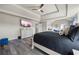 Comfortable bedroom featuring wood floors and a large TV at 1861 Poplar Falls Ave, Lithonia, GA 30058