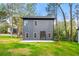 The backyard features lush green grass, mature trees, and a concrete patio for entertaining at 2869 4Th Sw St, Atlanta, GA 30315