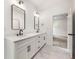 Modern bathroom featuring double vanity, sleek black fixtures, and marble flooring at 2869 4Th Sw St, Atlanta, GA 30315