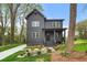 Charming two-story home featuring a covered porch and meticulously landscaped front yard at 2869 4Th Sw St, Atlanta, GA 30315