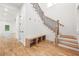 Bright foyer with wooden staircase, hardwood floors, and a built-in bench seating at 2869 4Th Sw St, Atlanta, GA 30315