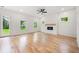 Sun-filled open space with hardwood floors, fireplace, and double doors leading to the backyard at 2869 4Th Sw St, Atlanta, GA 30315