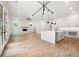 Bright open-concept living area showcases modern lighting, fireplace, and open flow to a gorgeous white kitchen at 2869 4Th Sw St, Atlanta, GA 30315