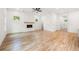 Living room with a sleek fireplace and open layout with hardwood floors and white walls with bright natural light at 2869 4Th Sw St, Atlanta, GA 30315