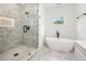 Elegant ensuite bathroom with marble floors, frameless glass shower, and modern soaking tub at 2869 4Th Sw St, Atlanta, GA 30315