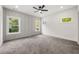 Main bedroom with large windows offering serene views, carpet, and stylish board and batten accent wall at 2869 4Th Sw St, Atlanta, GA 30315