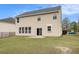 Spacious backyard featuring a well-maintained lawn and a sliding door to the house at 4355 Rainer Dr, Atlanta, GA 30349