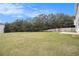 Large backyard with lush lawn, framed by mature trees and a wooden fence for privacy at 4355 Rainer Dr, Atlanta, GA 30349