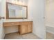 Stylish bathroom vanity with a decorative wood-framed mirror and warm lighting at 4355 Rainer Dr, Atlanta, GA 30349