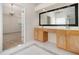 Bathroom vanity area featuring dual sinks and a large mirror with wood cabinets at 4355 Rainer Dr, Atlanta, GA 30349