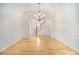 Bright dining area featuring hardwood floors, wainscoting, and an elegant chandelier, ideal for hosting dinners at 4355 Rainer Dr, Atlanta, GA 30349