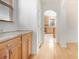 Hallway featuring hardwood floors and a view into the kitchen area, adding to the home's cohesive design at 4355 Rainer Dr, Atlanta, GA 30349