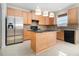 Bright kitchen boasts stainless steel refrigerator, dark countertops, and wooden cabinets at 4355 Rainer Dr, Atlanta, GA 30349