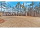 Spacious backyard ready for landscaping and recreation, surrounded by lush trees at 4444 Sullivan Rd, Powder Springs, GA 30127