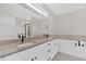 This bathroom has a double vanity with granite counters and a soaking tub at 4444 Sullivan Rd, Powder Springs, GA 30127