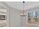 Bright dining area with modern chandelier and large windows with wooded view at 4444 Sullivan Rd, Powder Springs, GA 30127