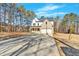 Wide concrete driveway leading to a charming house with brick and siding at 4444 Sullivan Rd, Powder Springs, GA 30127