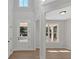 Light-filled foyer with a high ceiling, bright white trim and a glass-paned front door at 4444 Sullivan Rd, Powder Springs, GA 30127
