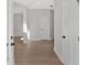 Bright hallway with hardwood floors, white doors, and neutral paint at 4444 Sullivan Rd, Powder Springs, GA 30127