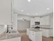 Bright kitchen features white cabinets, granite countertops, stainless steel appliances, and a kitchen island at 4444 Sullivan Rd, Powder Springs, GA 30127