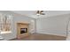Spacious living room featuring a brick fireplace, hardwood floors and large windows at 4444 Sullivan Rd, Powder Springs, GA 30127