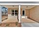 Inviting covered porch with brick columns and a white door, perfect for relaxing outdoors at 4444 Sullivan Rd, Powder Springs, GA 30127