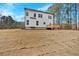 Rear exterior view of a modern two-story home with an inviting wooden deck and newly installed sod at 4444 Sullivan Rd, Powder Springs, GA 30127