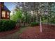 Serene backyard features lush greenery, a peaceful wooded area, and a charming black metal fence at 145 Cuthbert Ln, Acworth, GA 30101