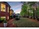 Expansive backyard with mature trees, iron fence, and outdoor dining area at 145 Cuthbert Ln, Acworth, GA 30101