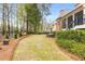 Spacious fenced backyard with established landscaping, bench, and outdoor dining area at 145 Cuthbert Ln, Acworth, GA 30101